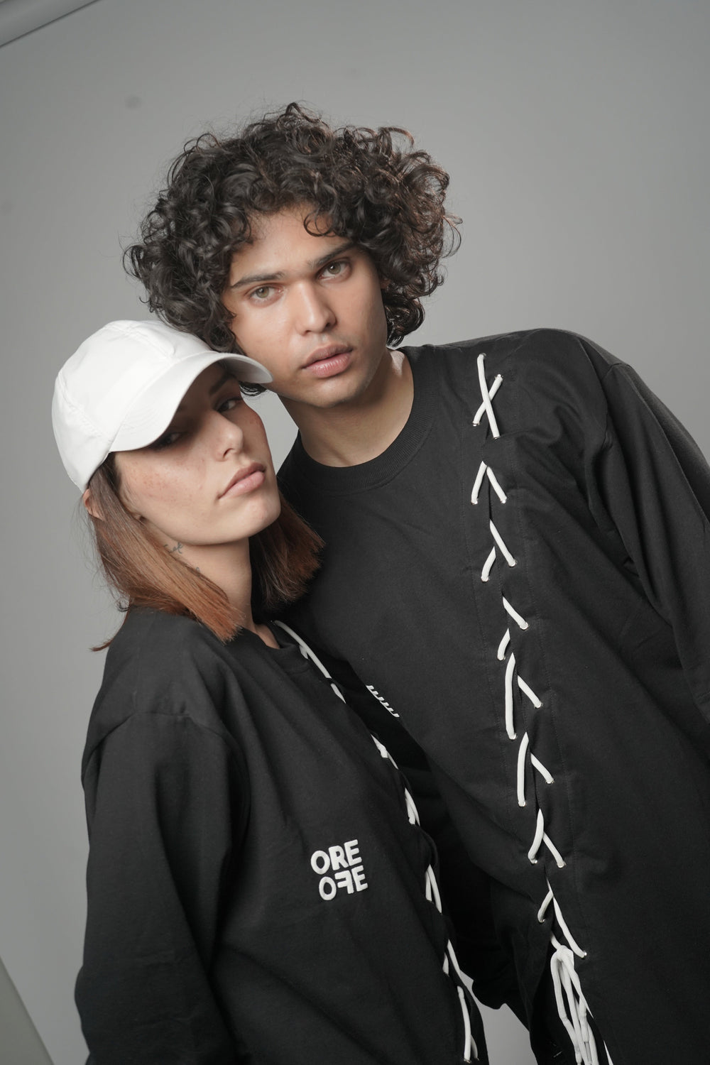 Male and female model wearing  full-length Korean oversized tee