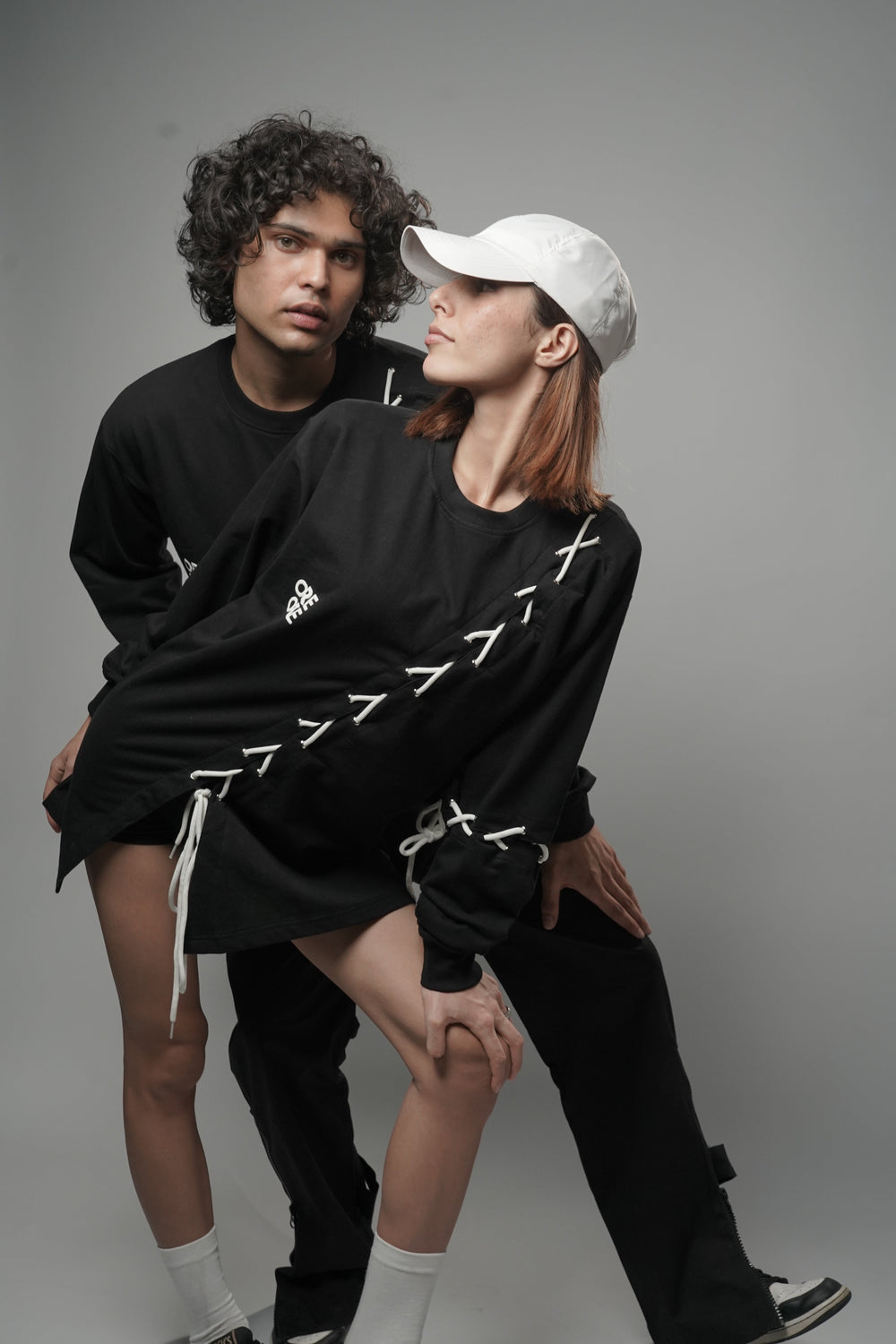 Male and female model wearing full-length Korean oversized tee