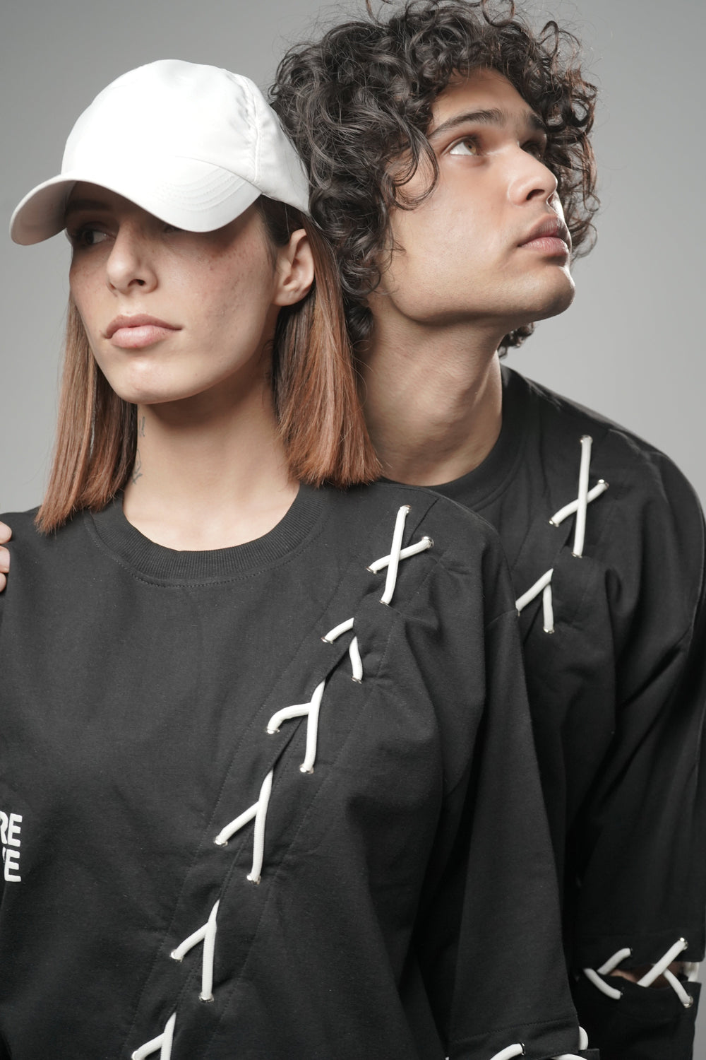 Male and female model wearing full-length Korean oversized tee