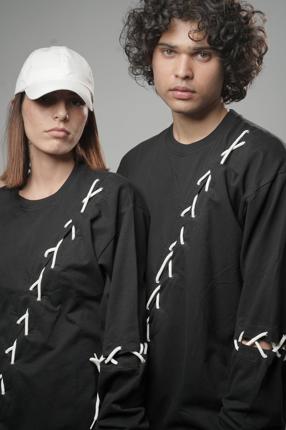 Male and female model wearing full-length Korean oversized tee
