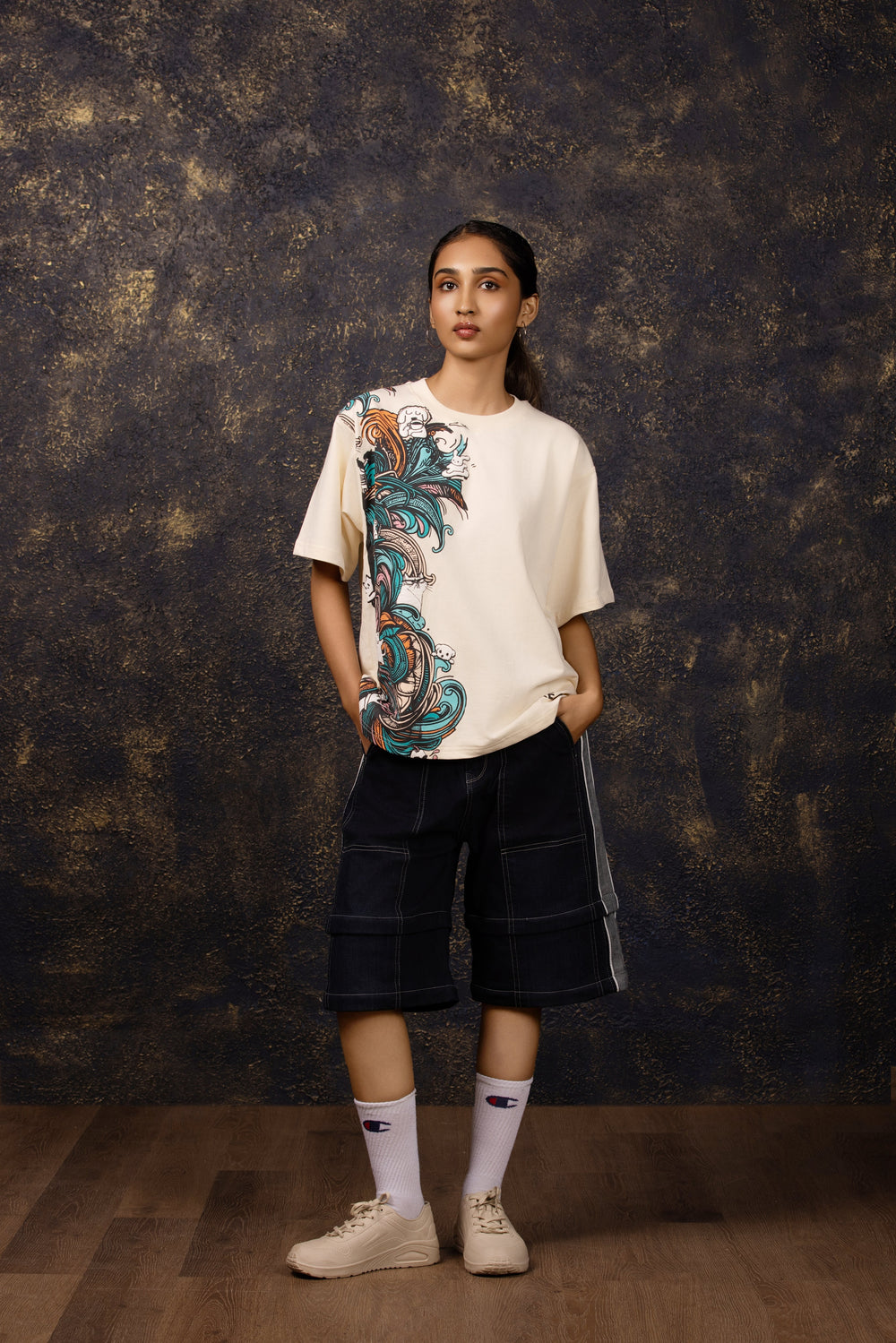 Model wearing an oversized tee featuring a whimsical hide and seek design