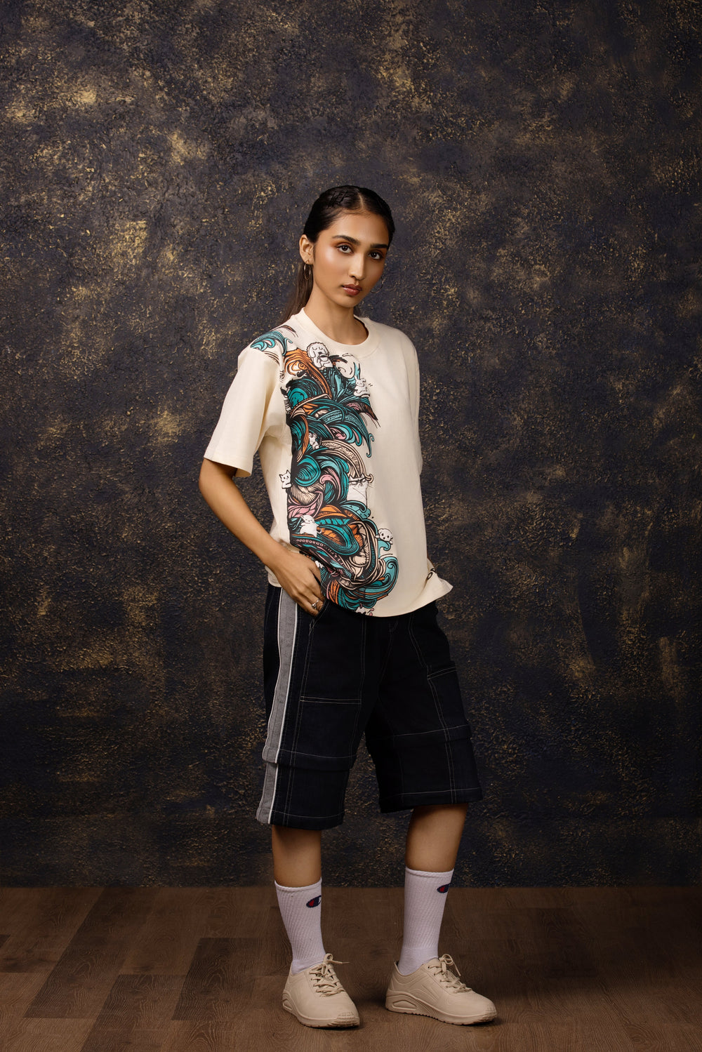 Model wearing an oversized tee featuring a whimsical hide and seek design