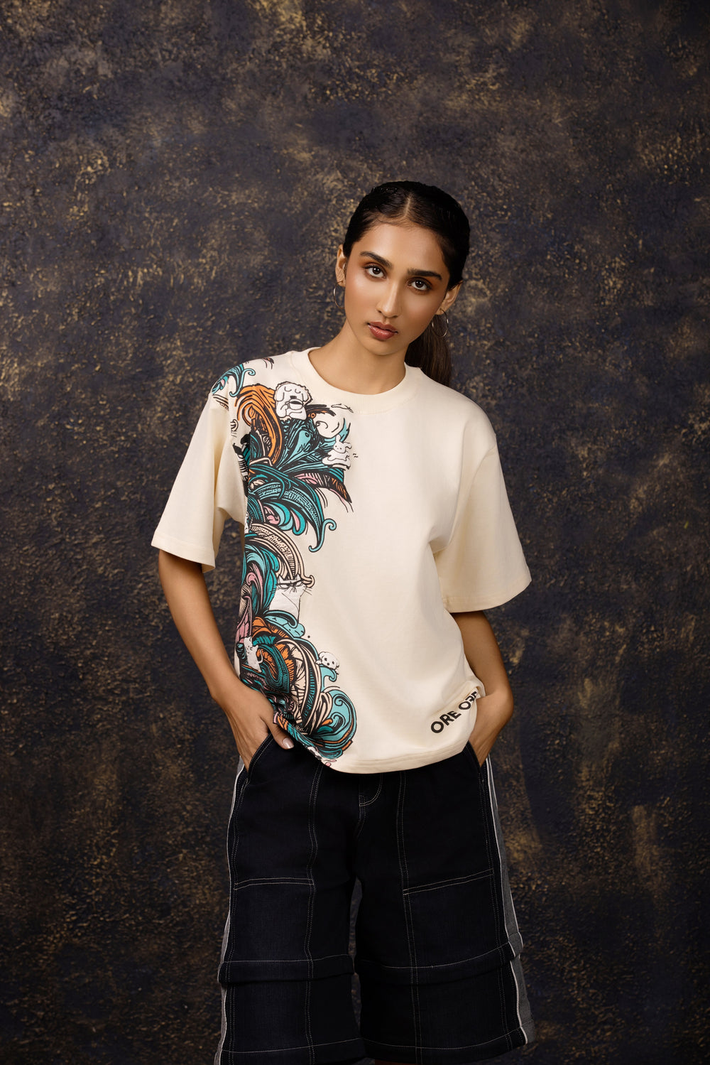 Model wearing an oversized tee featuring a whimsical hide and seek design