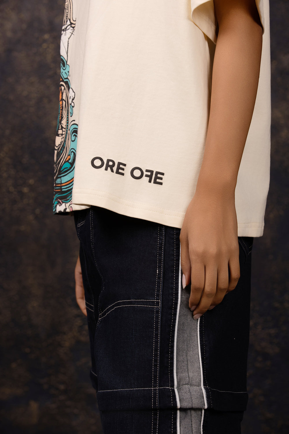 focused shot of Model wearing an oversized tee featuring a whimsical hide and seek design
