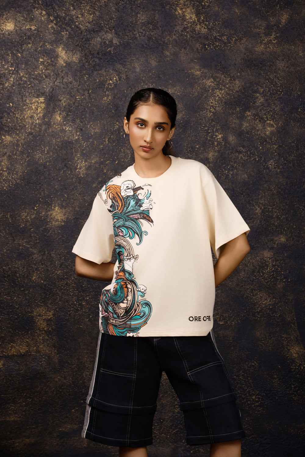 Model wearing an oversized tee featuring a whimsical hide and seek design