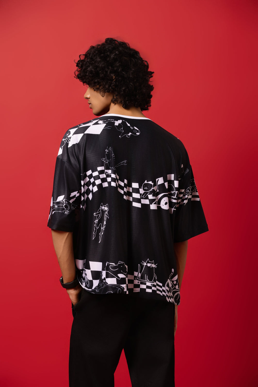 Model wearing an oversized shirt inspired by baseball jerseys, featuring a bold racing mania design print
