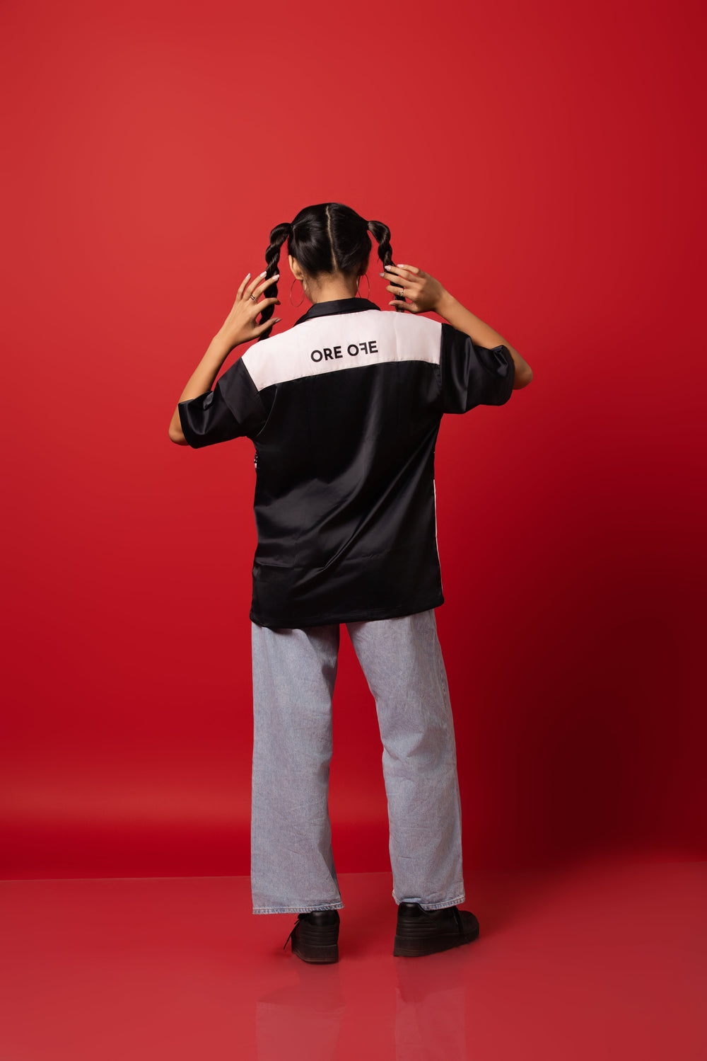 Model wearing the buttoned-down shirt made from Silk Satin, featuring a sublimation print.