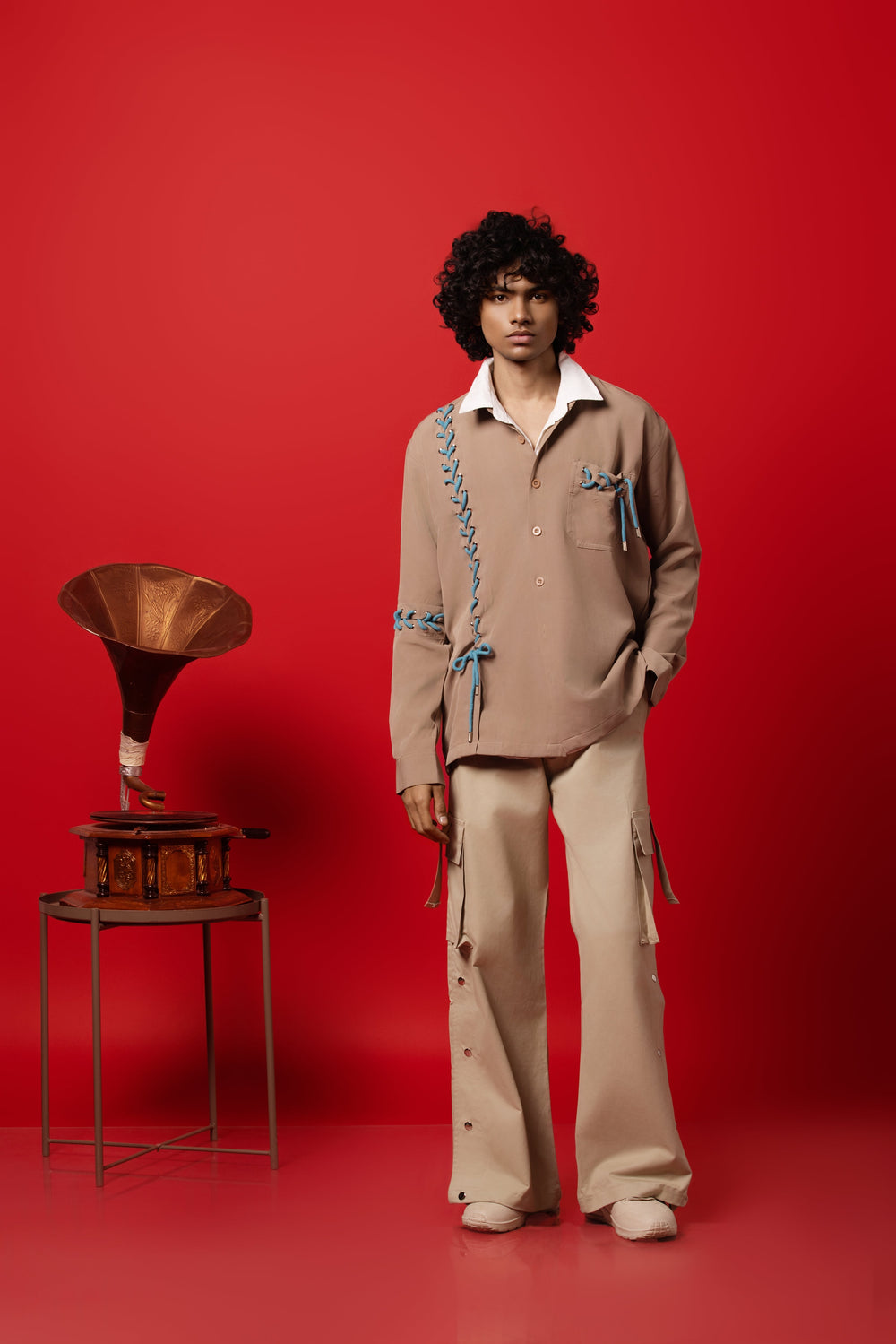 Male Model wearing a bold, edgy beige dropped shoulder shirt made from Banana Crepe fabric.