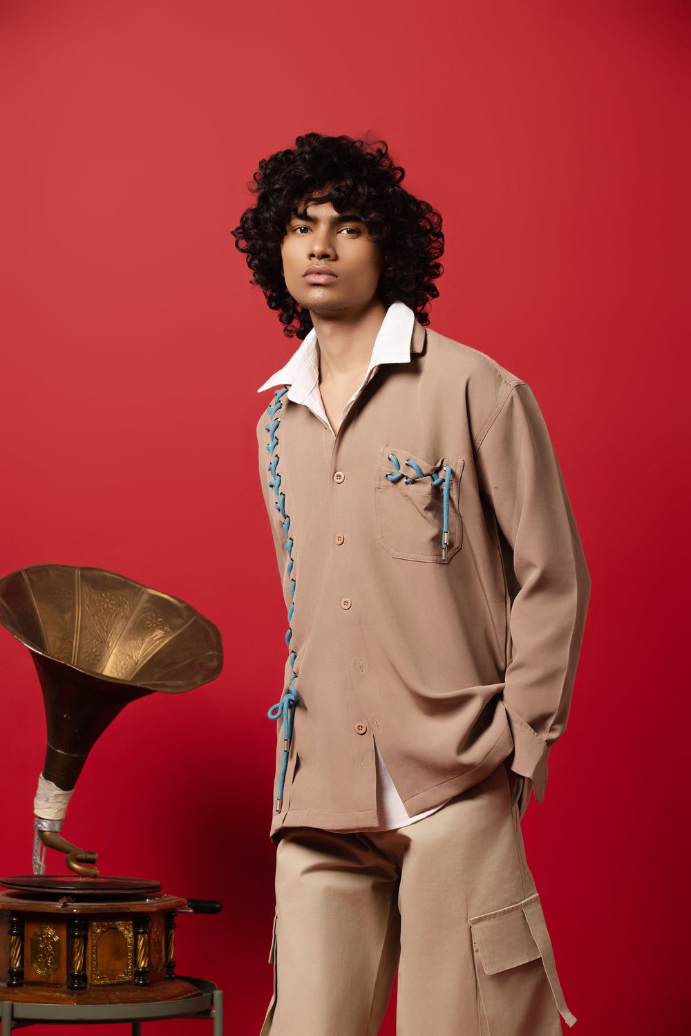 Male Model wearing a bold, edgy beige dropped shoulder shirt made from Banana Crepe fabric.